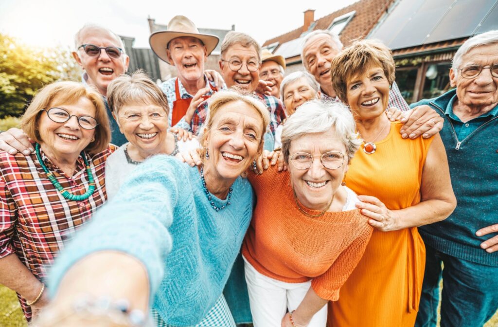 a group of seniors taking selfie all together in an assisted living community